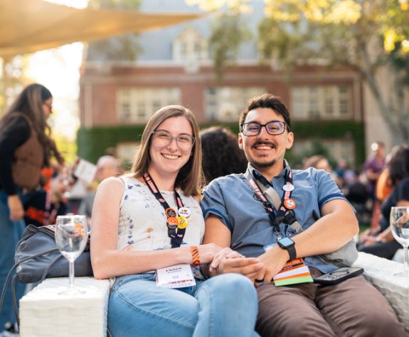 A man and a woman sitting on a couch and smiling