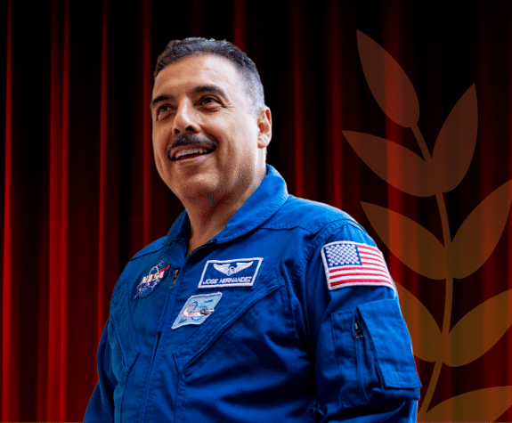 An image of Jose Hernandez in front of a dark red background