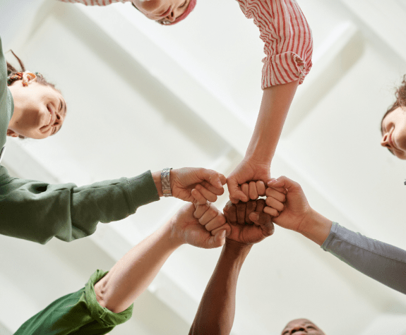Photo by Julia M Cameron: https://www.pexels.com/photo/people-in-circle-formation-doing-fist-bump-6995402/