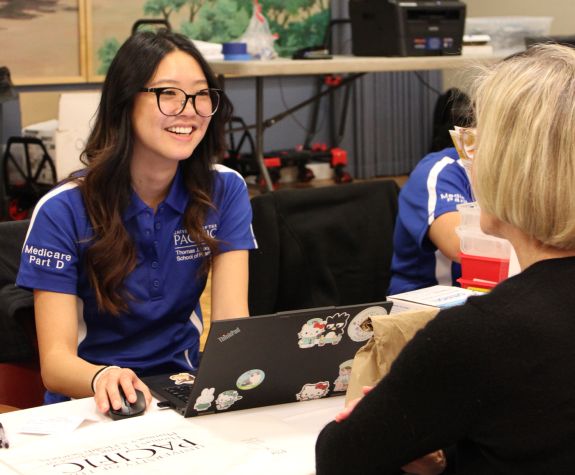 PharmD student with patient at Medicare Part D Outreach Clinic