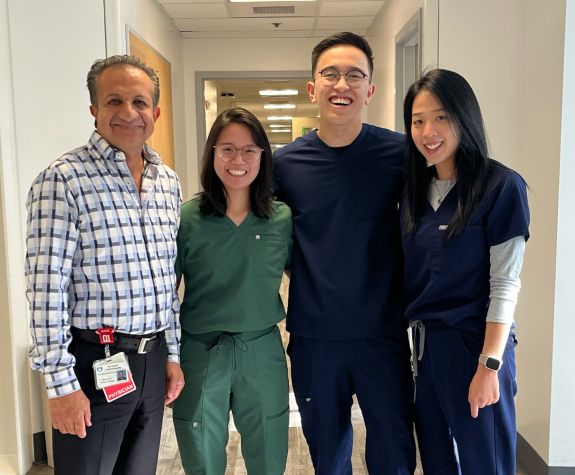 Three pharmacy fellows with a physician at a hospital site