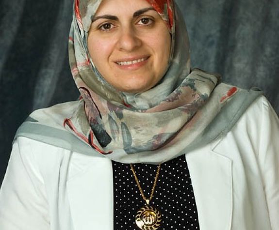 The photo shows the smiling face of Dr. Nassrine Noureddine.