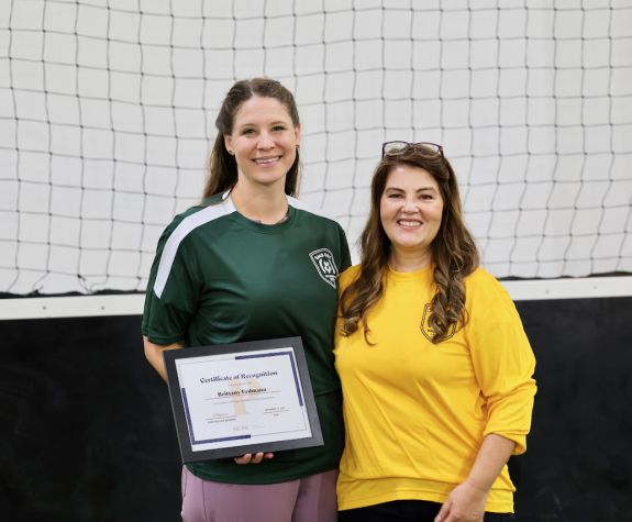The Dean is shown presenting a scholarship to a PA Student.
