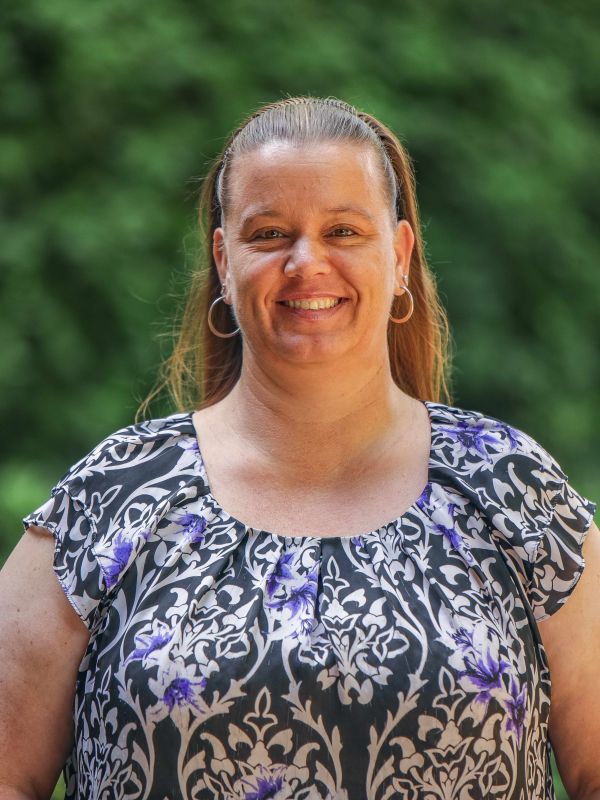 Woman smiles for a headshot 