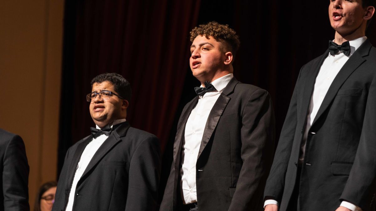 Filo in a choir ensemble concert in 2022