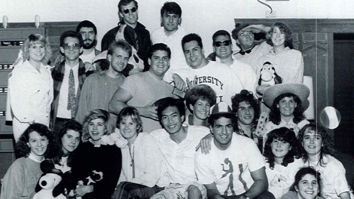 A large group of students poses together in Southwest Hall. 