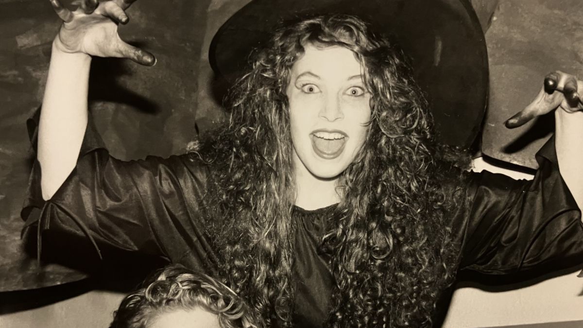 A student dressed as a witch poses for the camera. 