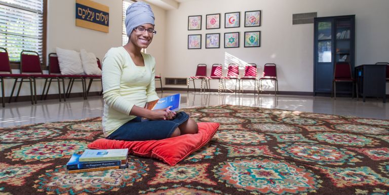 Student kneeling in sacred space