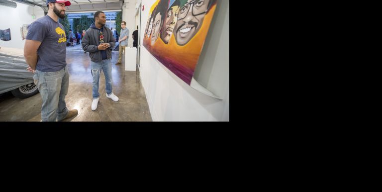 students looking at artwork on wall