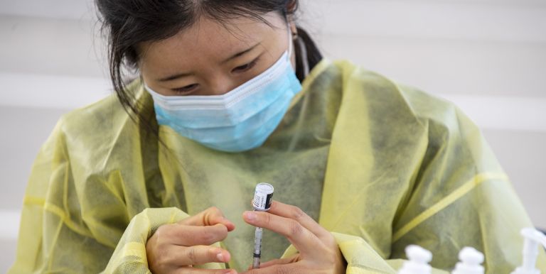 student drawing vaccine
