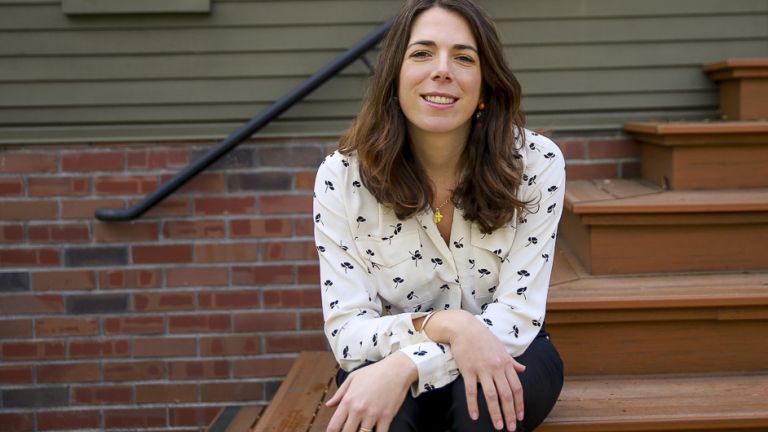 McGeorge Assistant Dean Clemence Kucera sitting on the steps of the McGeorge House