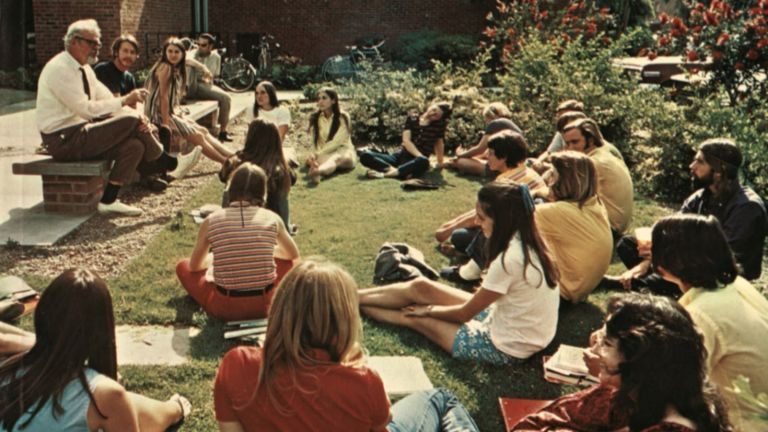 a professor reaches a class on a lawn in the 1970s
