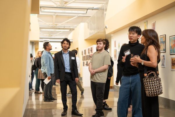 attendees observe a Reynolds Gallery exhibition