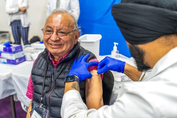 PharmD student with patient at health care outreach clinic