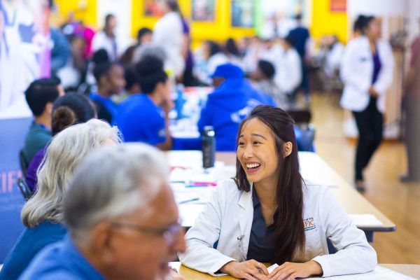 PharmD student with a patient at a Medicare Part D Outreach Clinic
