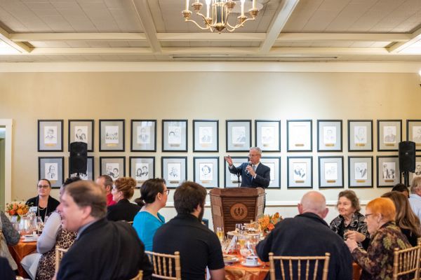 a speaker in the Regents Dining Room