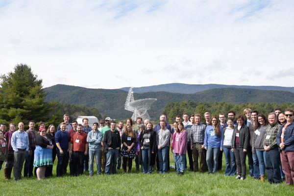 astronomers in front of a radio telescope