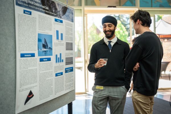 a student presents a poster presentation