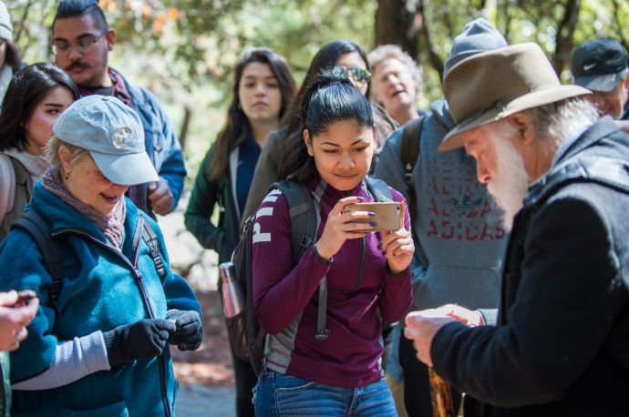 student taking picture of tour guide