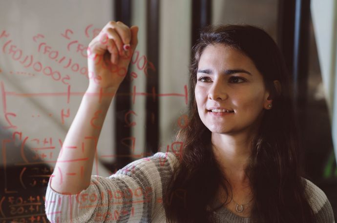 math student writing on glass