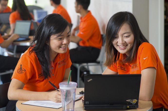 Two PharmD students with laptops