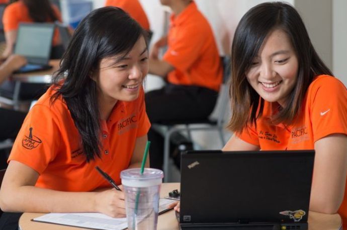 Two PharmD students with laptops