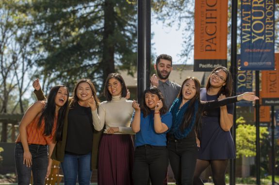 A group of students smile and pose for the camera.