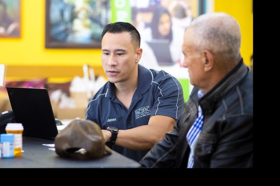 PharmD student with patient at Medicare Part D Outreach Clinic