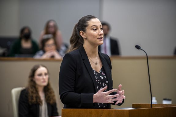 A woman speaks at a podium