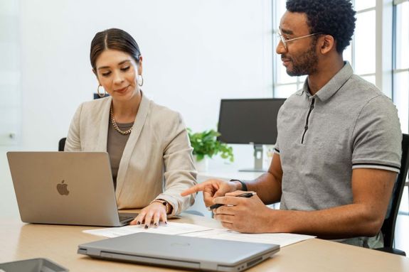 Students discussing over a laptop