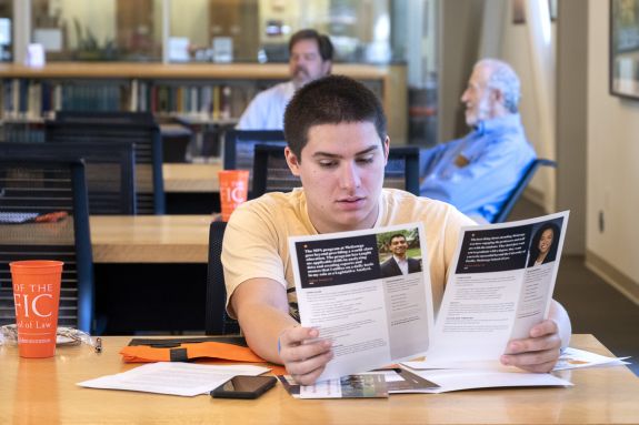 students looks at info papers 
