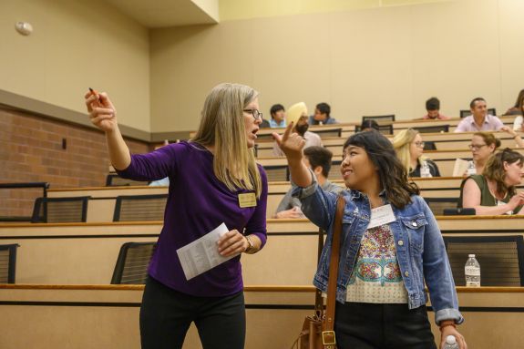 A student speaks to a staff member.