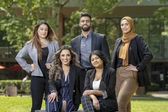 Five students pose for a photo