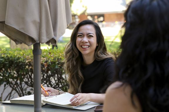 A law students sits outside.