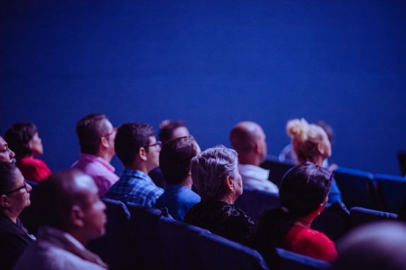 People Sitting on Chairs in an auditorium 