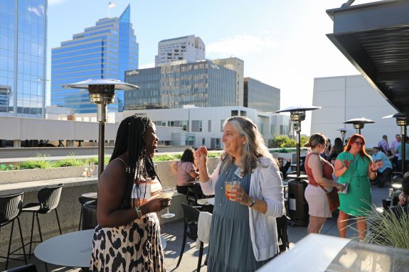 Two women talk to each other