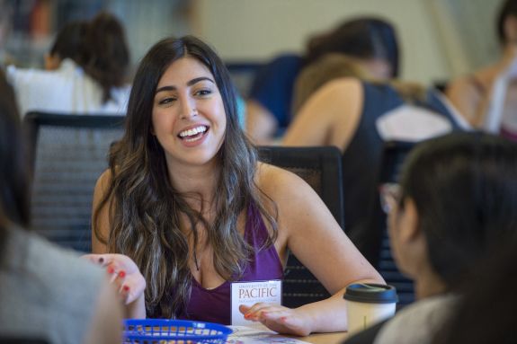 Girl in purple top smiles