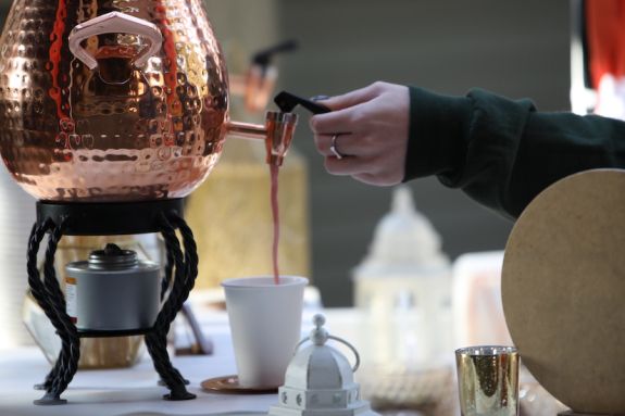 Hand pours coffee