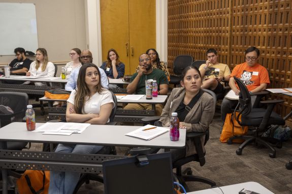 students listen in on an info session