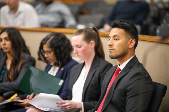 A law student sits in a courtroom.