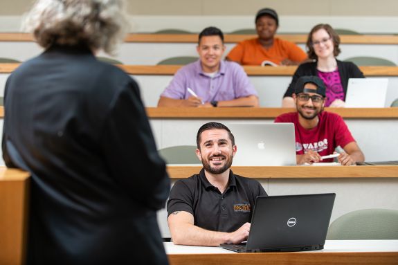 Students in a classroom listen to a lecture