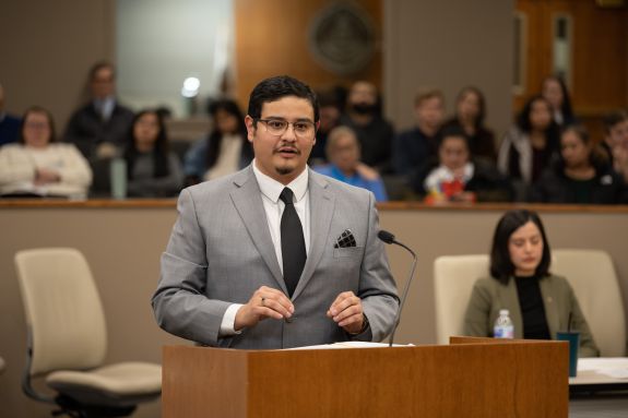 Man in grey suit speaks in courtroom