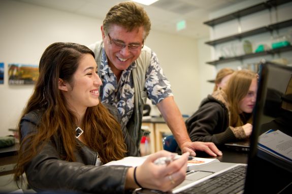 Professor Tenaza helping a student