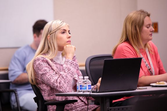 A student sits in a lecture hall.