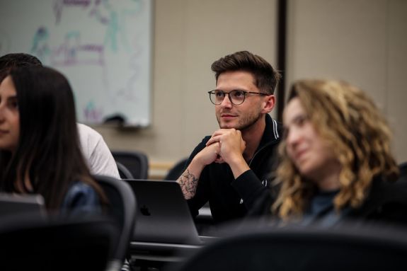 A student sits in a lecture hall.