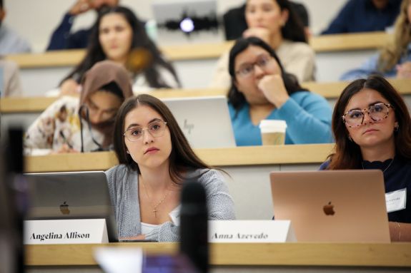 A student sits in a lecture hall.