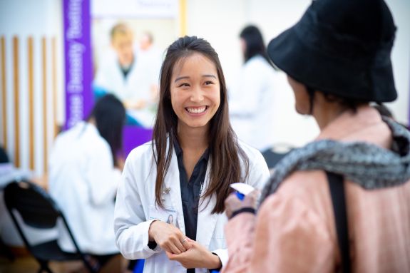 Pharmacy student welcoming patient.