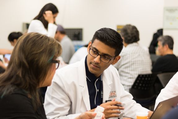 Pharmacy student consulting patient.