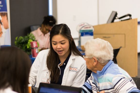 Pharmacy student consulting patient.