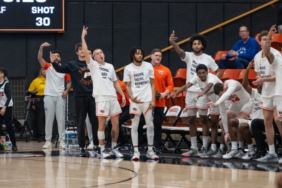 Men's basketball bench celebrates
